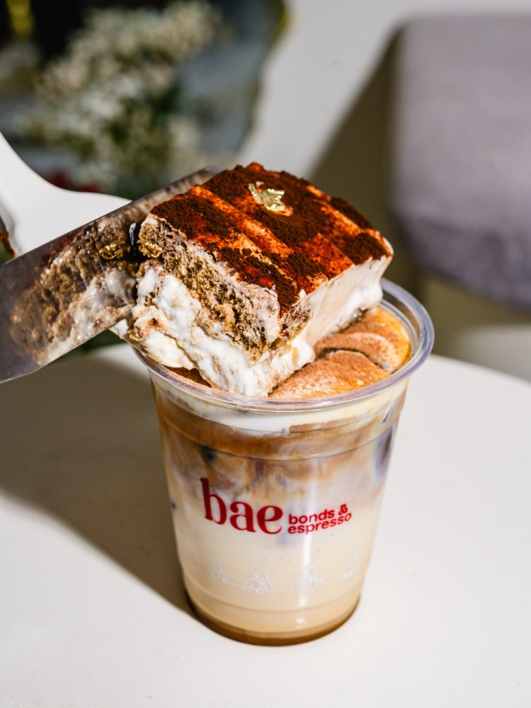 Tiramisu Iced Latte topped with a slice of tiramisu